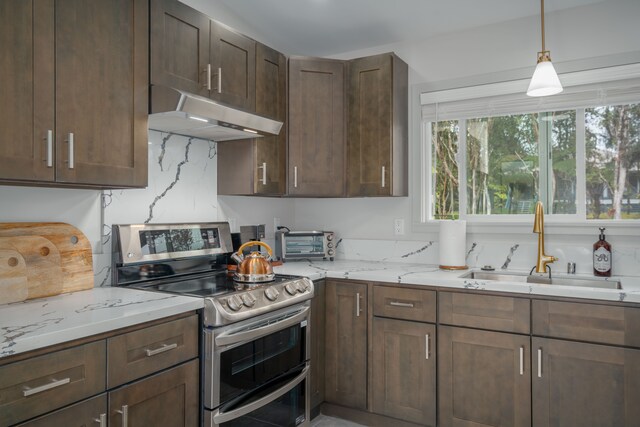 kitchen with backsplash, stainless steel range with electric cooktop, sink, dark brown cabinets, and light stone counters