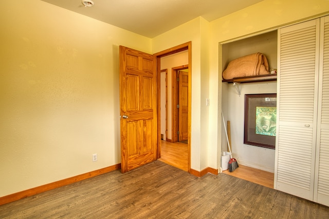 unfurnished bedroom featuring a closet and wood-type flooring