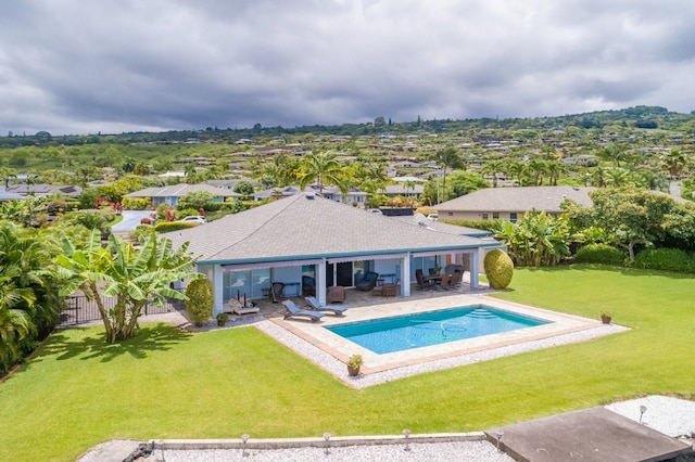 rear view of property featuring a yard and a patio