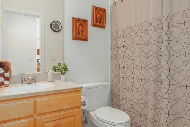 bathroom with vanity, toilet, and a shower with shower curtain