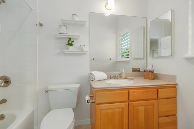 full bathroom with vanity, tiled shower / bath combo, and toilet