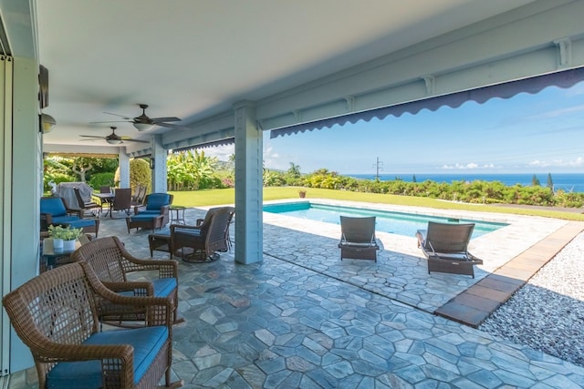 view of patio with a water view and ceiling fan