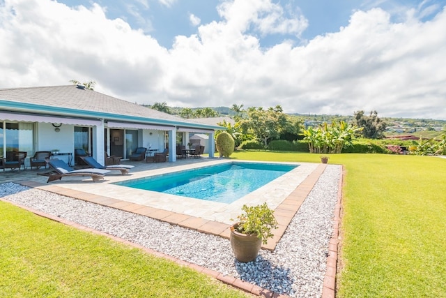 view of swimming pool with a yard and a patio