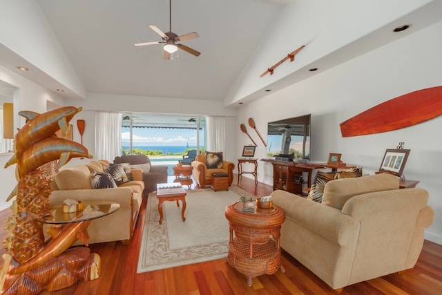 living room with wood-type flooring, high vaulted ceiling, and ceiling fan