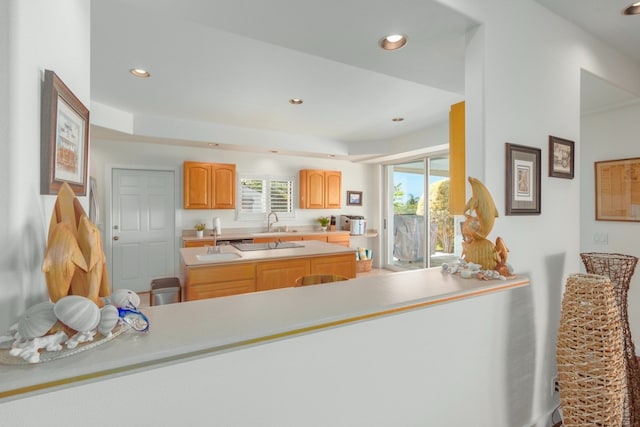 kitchen featuring kitchen peninsula, sink, and plenty of natural light