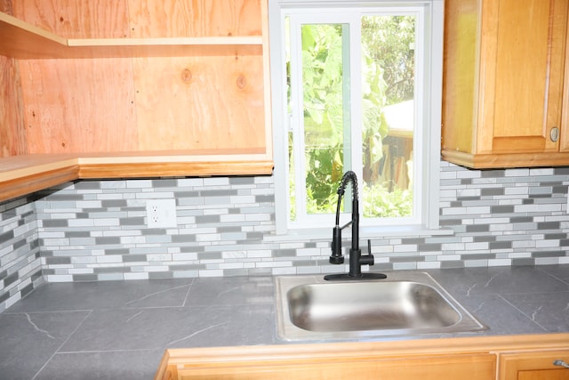 kitchen with decorative backsplash, sink, and plenty of natural light