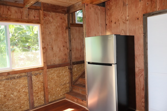 kitchen featuring dark wood-type flooring and stainless steel fridge