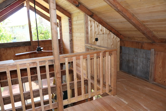 interior space with hardwood / wood-style flooring, wooden ceiling, vaulted ceiling with beams, and wood walls