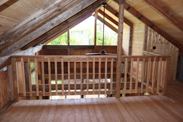 exterior space featuring lofted ceiling, wood ceiling, hardwood / wood-style flooring, and wood walls