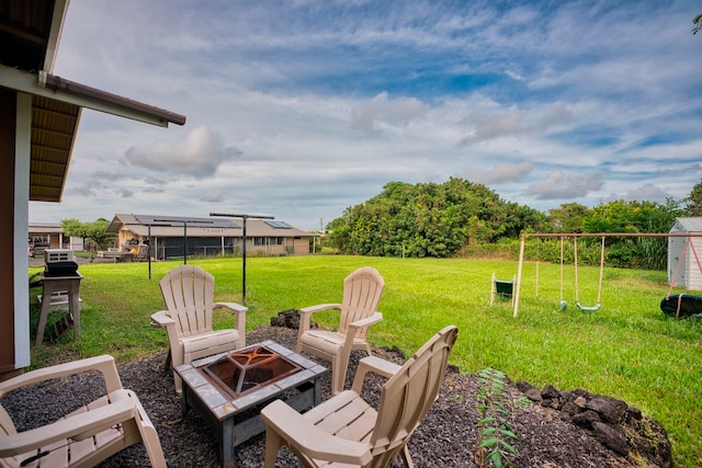 view of yard featuring an outdoor fire pit