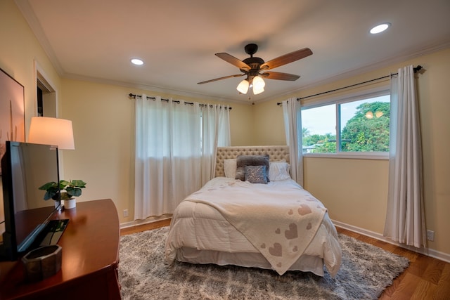 bedroom with ornamental molding, wood-type flooring, and ceiling fan