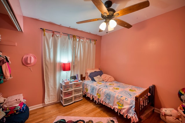 bedroom featuring hardwood / wood-style floors and ceiling fan