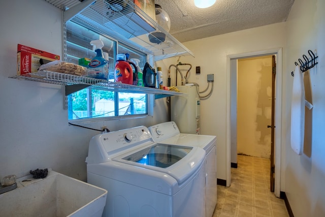 laundry room featuring a textured ceiling, water heater, sink, and washer and dryer