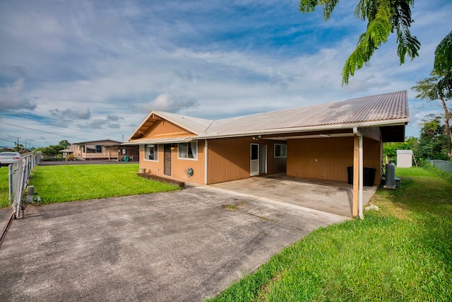 single story home with a front lawn and a carport