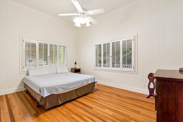 bedroom with ceiling fan, multiple windows, ornamental molding, and light hardwood / wood-style flooring