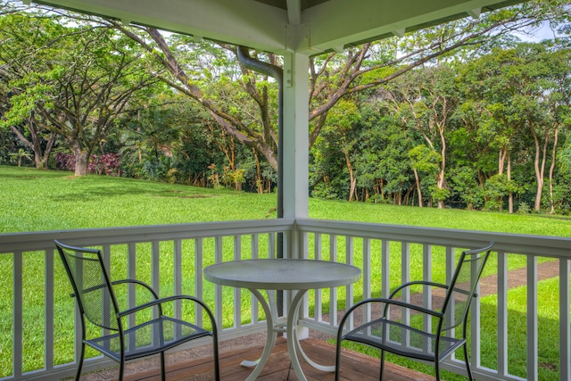 wooden deck featuring a yard