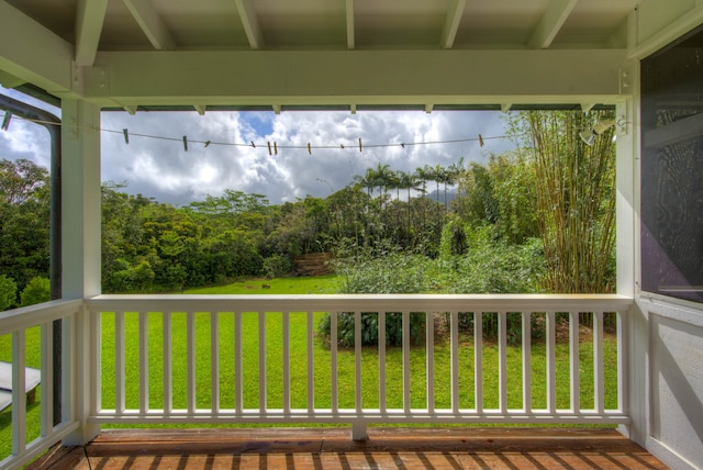 wooden terrace with a lawn