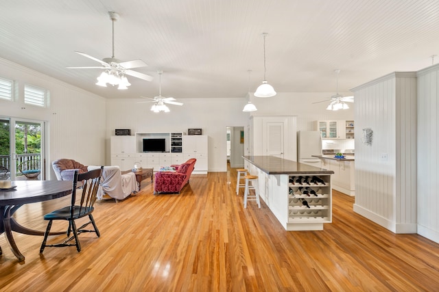6140 Kahiliholo Rd, Kilauea, HI 96754 - living area with a ceiling fan, light wood finished floors, crown molding, and baseboards