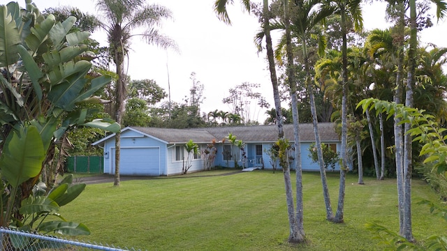 ranch-style home with a front lawn and a garage