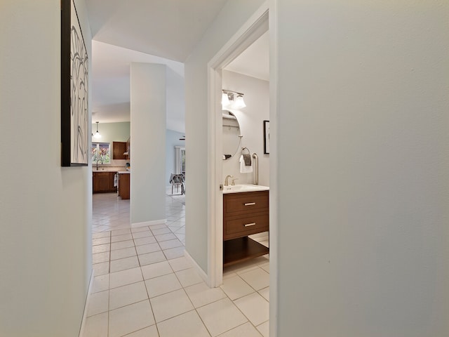 hall with sink and light tile patterned floors