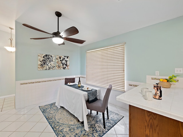 tiled dining area featuring ceiling fan