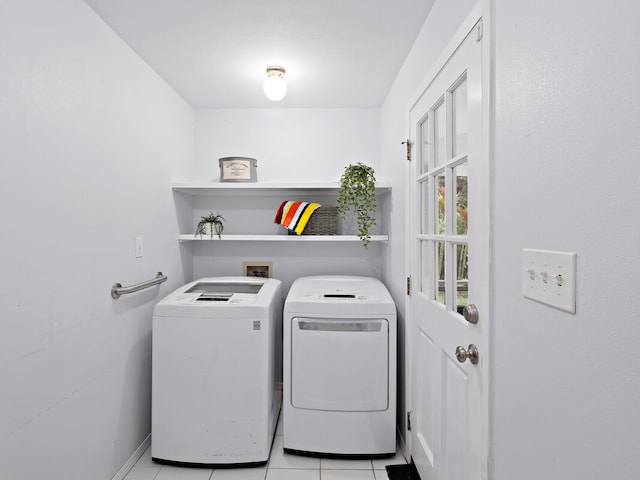 washroom featuring washing machine and dryer and light tile patterned floors