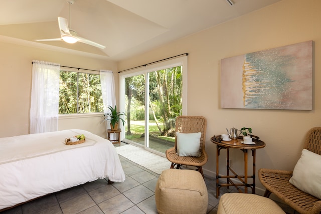 bedroom featuring ceiling fan, multiple windows, tile patterned flooring, and access to exterior