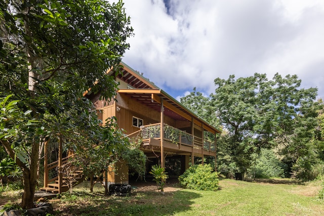 rear view of property with a lawn