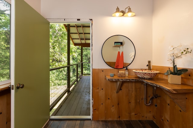 doorway to outside with a healthy amount of sunlight, sink, and dark hardwood / wood-style floors