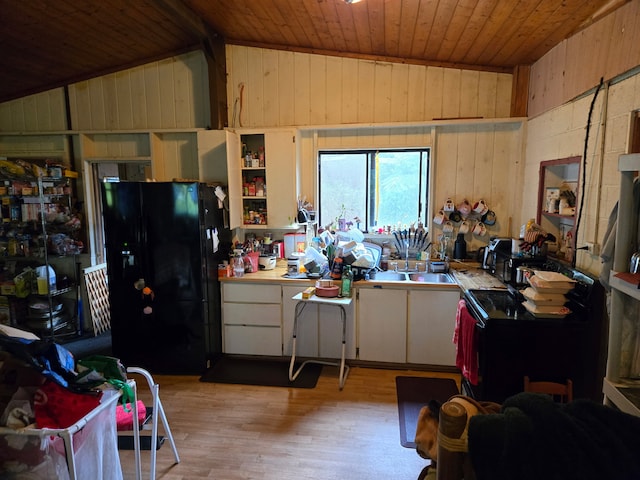 16-1248 Uhini Ana Rd, Mountain View, HI 96771 - kitchen with lofted ceiling, wooden ceiling, wooden walls, and black fridge
