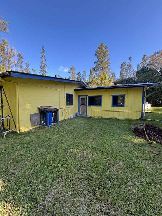 16-1248 Uhini Ana Rd, Mountain View, HI 96771 - back of property with concrete block siding and a lawn