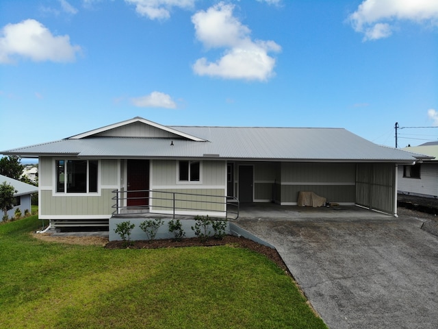 ranch-style home featuring a front yard and a carport