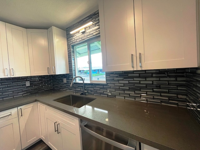 kitchen with white cabinetry, tasteful backsplash, dishwasher, and sink