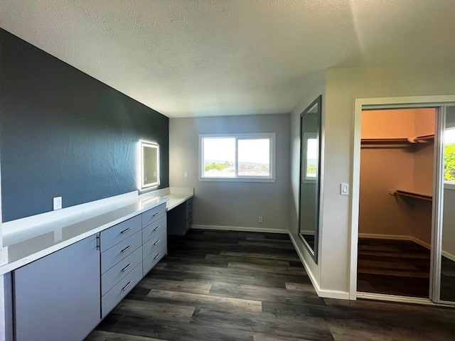 bathroom featuring vanity, hardwood / wood-style flooring, a textured ceiling, and walk in shower