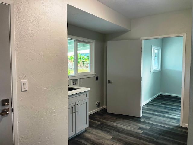 interior space featuring vanity, a textured ceiling, and hardwood / wood-style flooring