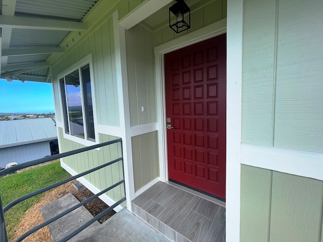 view of exterior entry featuring a porch