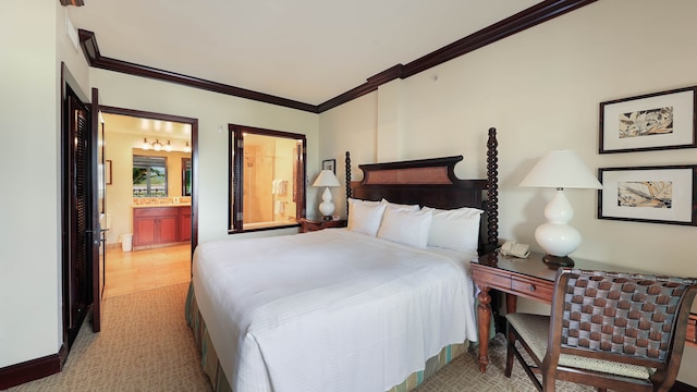 bedroom with crown molding, light colored carpet, and ensuite bath