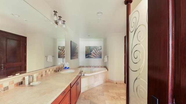 bathroom featuring vanity and tiled bath