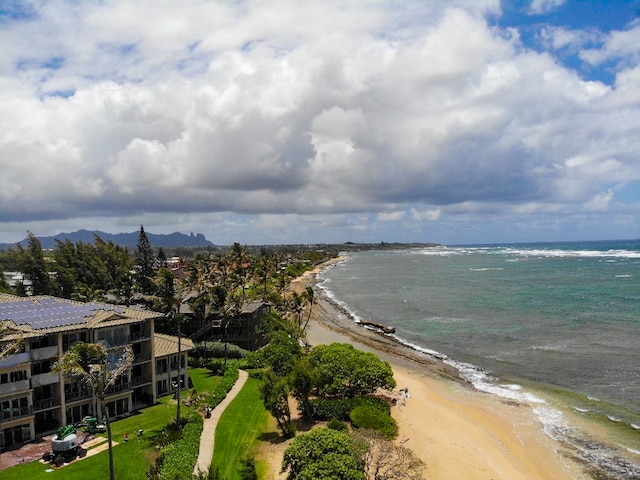 drone / aerial view with a water view and a beach view