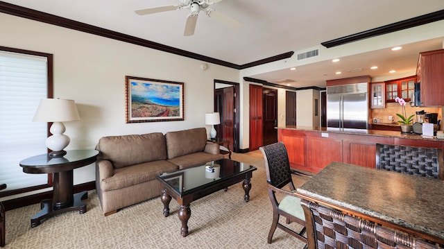 carpeted living room with crown molding and ceiling fan