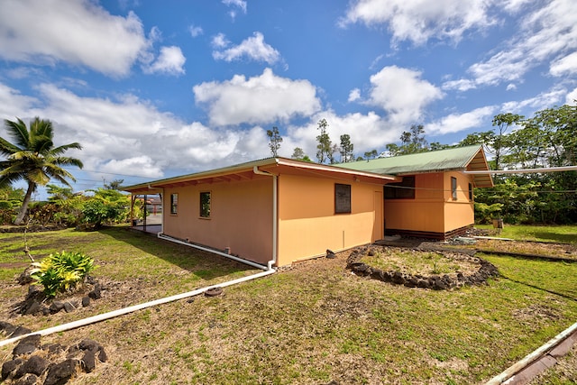 view of property exterior with a yard