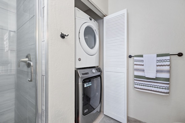 washroom featuring stacked washer and dryer