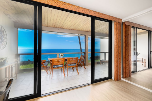 entryway with hardwood / wood-style flooring and a water view