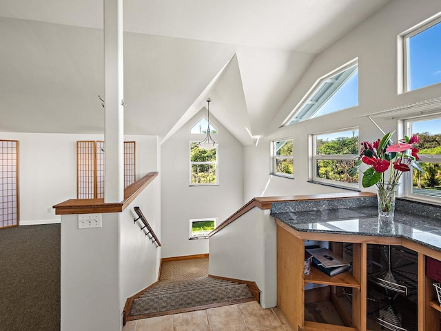 staircase featuring carpet flooring and lofted ceiling