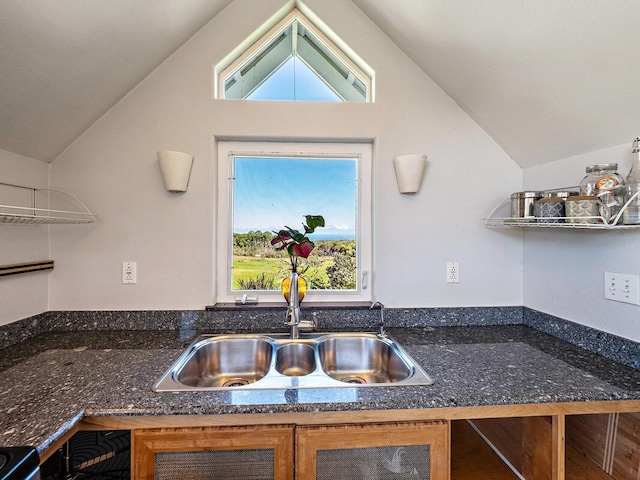 kitchen featuring lofted ceiling and sink