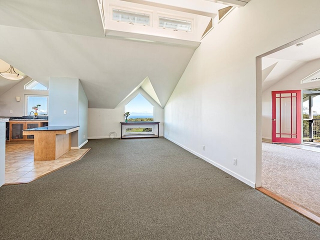 bonus room with carpet flooring, sink, and lofted ceiling