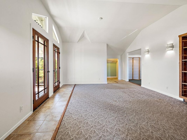 entryway featuring french doors, carpet floors, and lofted ceiling