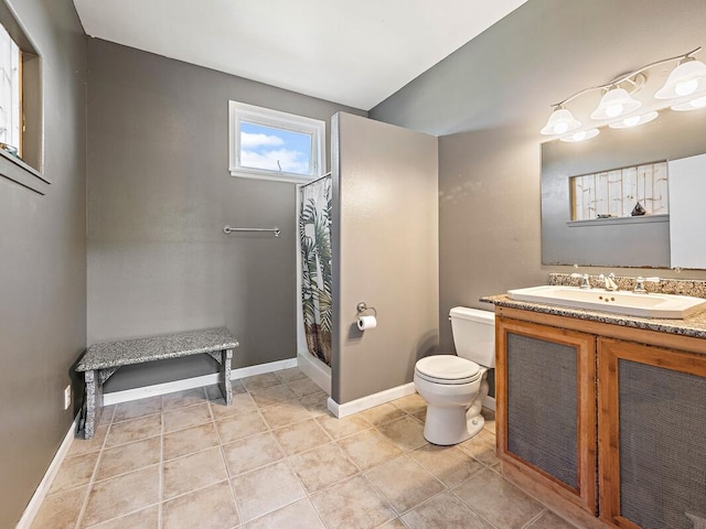 bathroom featuring tile patterned floors, vanity, and toilet