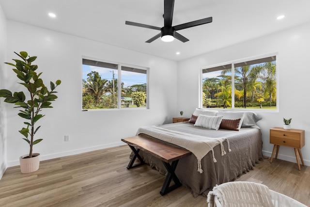 bedroom with light hardwood / wood-style flooring and ceiling fan