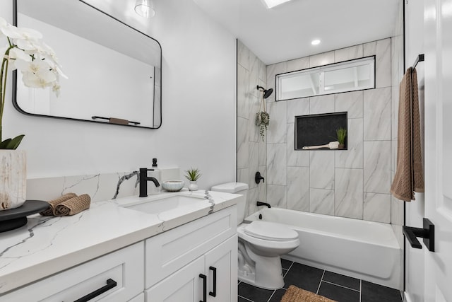 full bathroom with toilet, vanity, tile patterned floors, and tiled shower / bath